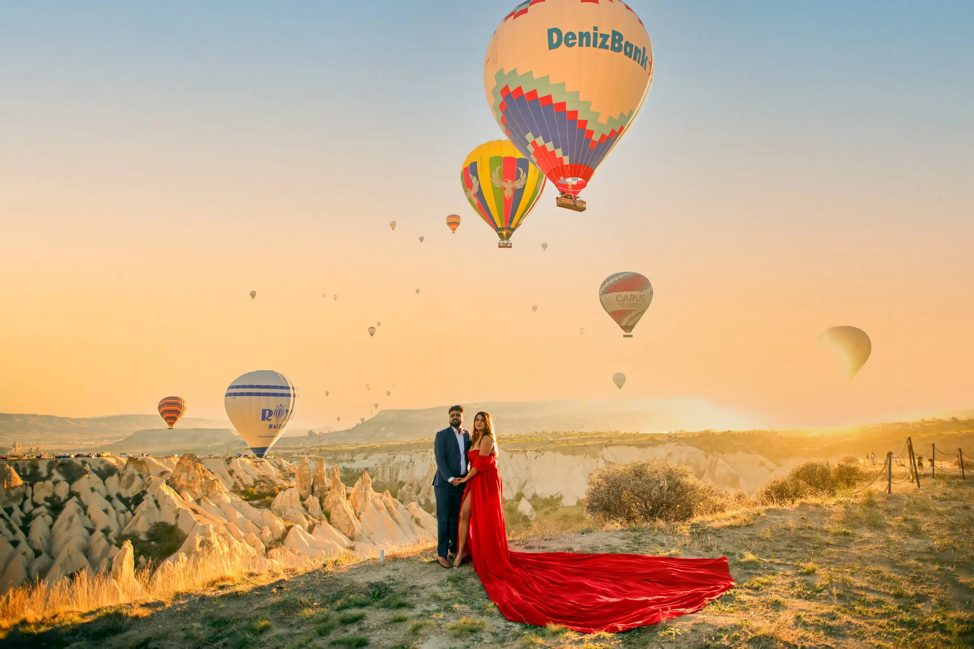 Couple at sunrise with hot-air balloons, international pre-wedding shoot